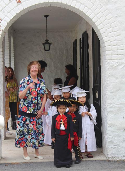 Dominican Sr. Jean Graffweg stands with House on the Hill students at their 2019 graduation ceremony. House on the Hill was founded in 1972 to educate children of migrant workers. It has since added many services, including health, disability and nutrition programs. (Courtesy of Sisters of St. Dominic of Blauvelt, New York)