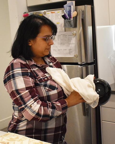 Maribah Ishaq, novice with the Sisters of Loretto at the Foot of the Cross, dries the dessert dishes at the InterCongregational Collaborative Novitiate in Chicago. (Julie A. Ferraro)