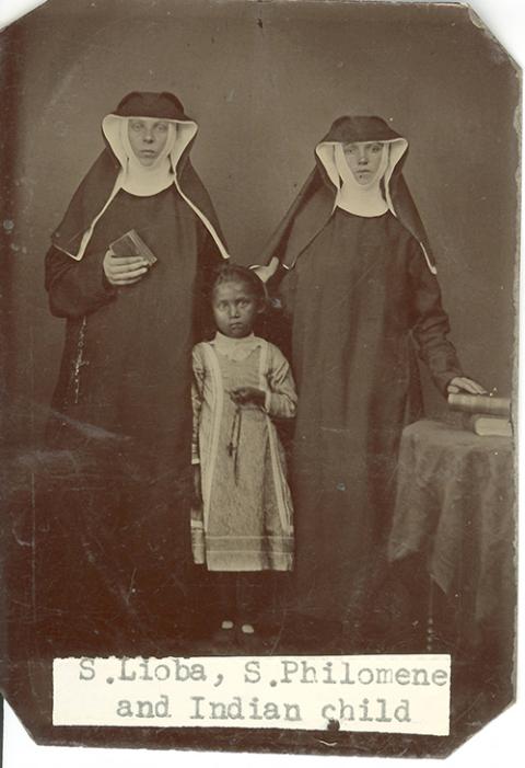 Benedictine Srs. Lioba Braun and Philomena Ketten pose for a photograph with a child presumed to be from the Ojibwe Tribe in the 1880s. Braun and Ketten were part of St. Benedict's Mission for members of White Earth Nation in Minnesota. ("Sisters Lioba Braun and Philomena Ketten with Ojibwe child," College of Saint Benedict/Saint John's University Libraries, https://csbsjulib.omeka.net/ items/show/923)