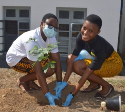 Students of Holy Child Secondary School in Ghana plant a tree in this photo. They are members of the environmental advocacy club, the "Global Warming Awareness Club." (Courtesy of Gifty Atampoka Abane)