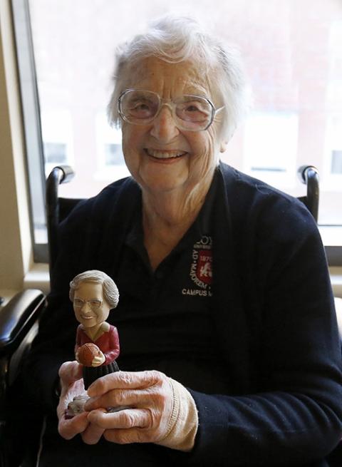 Sr. Jean Dolores Schmidt holds a bobblehead made in her likeness while recuperating from hip surgery in January 2018. (CNS/Chicago Catholic/Karen Callaway)