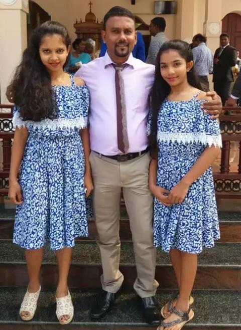 Nethmi and Vishmi, two daughters of Niranjalee Yasawaradana, with their father Sampath Wickramaratna just before the Easter Mass April 21, 2019, at St. Sebastian's Church. All three died in the suicide attack during the Mass. (Courtesy of Niranjalee Yasawaradana)