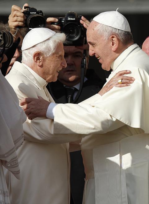 Pope Francis greets retired Pope Benedict XVI during an encounter for the elderly in St. Peter's Square Sept. 28, 2014, at the Vatican. (CNS/Paul Haring)