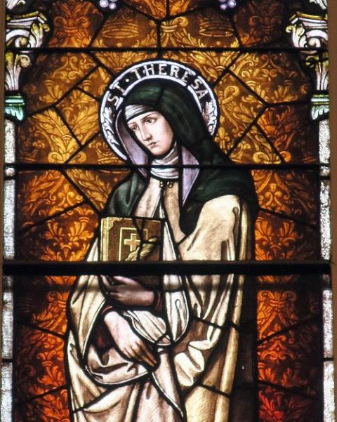 St. Teresa of Avila, who founded the convent of Discalced Carmelite Nuns in 1562, is depicted in a detail of a stained glass window at Holy Rosary Catholic Church in Indianapolis, Indiana. 