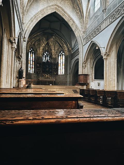 The nave or sanctuary of Benedictine Nonnberg Abbey, featuring Gothic architectural design elements and the reflected light of early dawn (Sarah Southern)