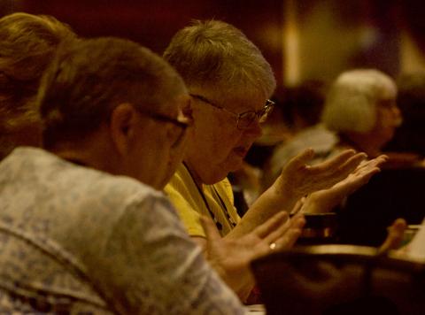 Participants at the Leadership Conference of Women Religious assembly bless the speakers during the gathering Aug. 9 in Dallas. (GSR photo/Dan Stockman)