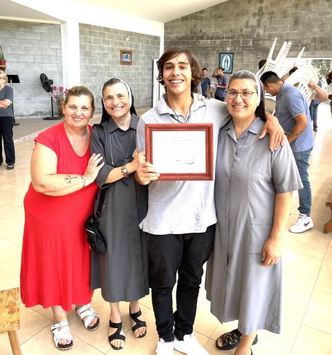 Sr. Graciela Trivilino, second from left, with one of the young adults who recovered at the fazenda, as he receives a diploma to become an "Ambassador of Hope" (Courtesy of Graciela Trivilino)