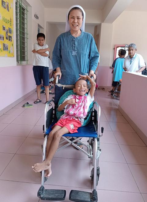  Sr. Andree Lee with a disabled child at Kkottongnae House of Hope in Gazipur (Sumon Corraya)