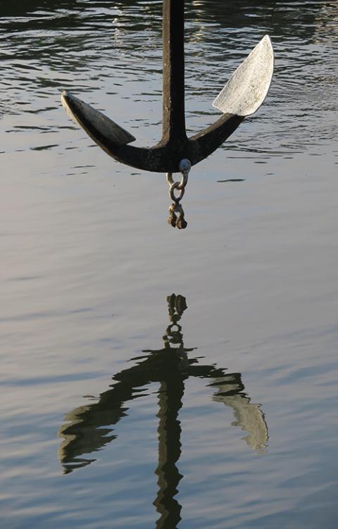 An anchor suspended above and reflected in water (Pixabay/Angelika Gruber)