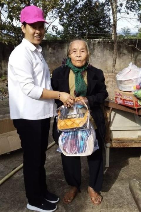 An 85-year- old Catholic woman receives a donation from a Dominican Sister of St. Rose of Lima in December 2022. (Mary Nguyen)