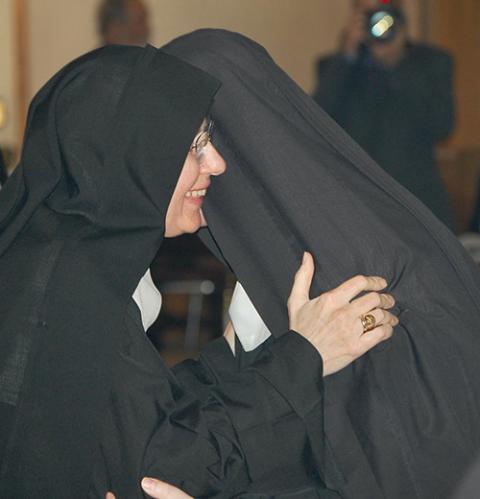 Mother Benedict McLaughlin, first abbess of the Benedictines' Immaculate Heart of Mary Abbey in Westfield, Vermont, greets a nun during her abbatial blessing Nov. 11 at St. Mary Star of the Sea Church in Newport, Vermont. (OSV News/Vermont Catholic magazine/Cori Fugere Urban)