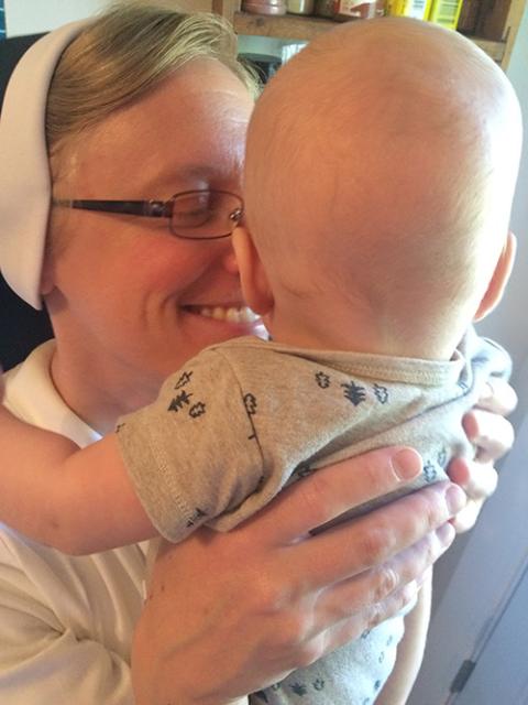 Apostle of the Sacred Heart of Jesus Sr. Kathryn Press meets her nephew in June 2020. (Courtesy of Kathryn Press) 