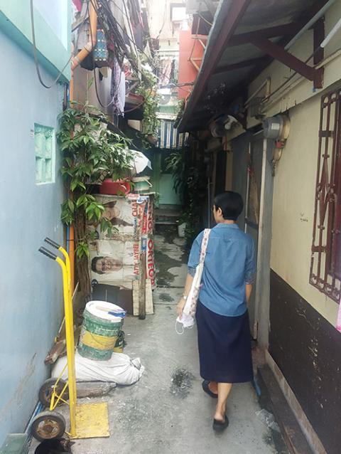 Sister Arabella, visiting mothers and women in their homes, heads toward Recy's house, just a few steps to her left, on Sept. 2, 2023, in Paco, Manila, Philippines. (Jerahmeel Cruz)