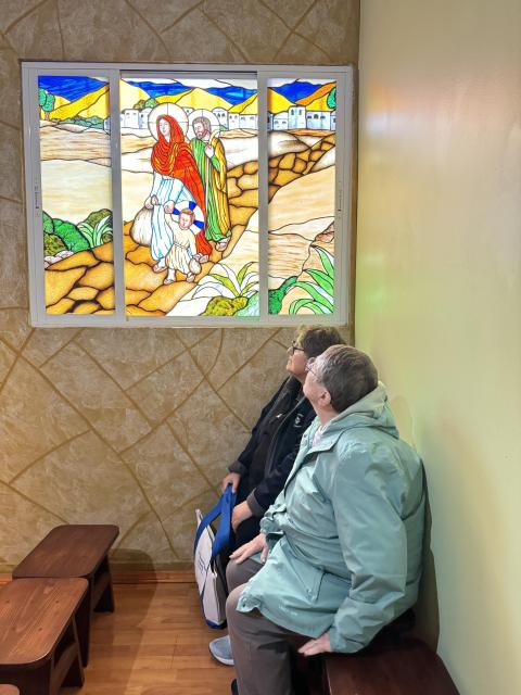 Sisters contemplate a stained-glass window depicting the Holy Family at a chapel inside the Instituto Madre Assunta shelter in Tijuana, Mexico, Feb. 6. The shelter, run by Scalabrinian sisters, was one of several stops for women and men religious on a five-day border pilgrimage Feb. 5-9 in and around San Diego as well as the U.S.-Mexico border. (GSR photo/Rhina Guidos)