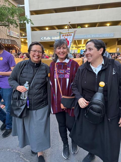 Elia Cardenas, a lay Dominican, center, marches with Dominican Srs. Gabriela Duran, right, and Gabriela Ramirez. Sisters from different congregations participated in the protest.