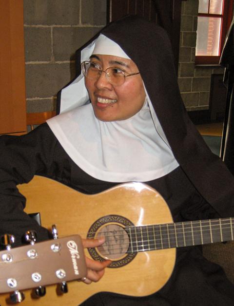 Benedictine Sr. Agnes Valderrama plays guitar. (Courtesy of Abbey of Sainte-Marie des Deux-Montagnes)