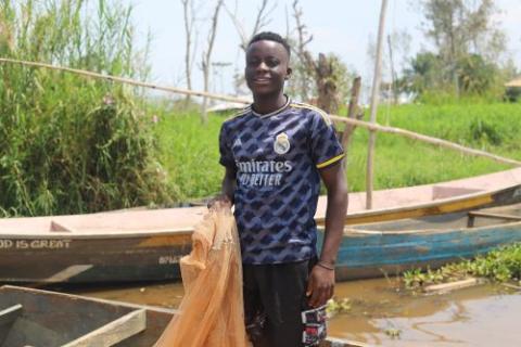 Joseph Ahadi, 17, cleans his fishing nets. Joseph Ahadi, 17, cleans his fishing nets.