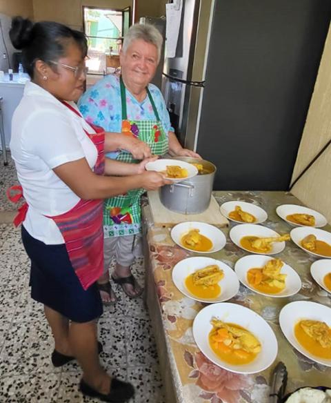Maryknoll Sr. Dee Smith, right, helping with the lunchtime program for resident HIV-positive people at the Hospicio Santa Maria/Proyecto Vida in Pajapita, San Marcos, Guatemala. She is seen with Sara, who is not HIV-positive but has lost relatives to HIV. (Photo courtesy of Dee Smith)