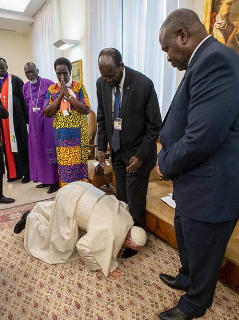 Pope Francis kisses the feet of South Sudan President Salva Kiir April 11, 2019, at the conclusion of a two-day retreat at the Vatican for African nation's political leaders. The pope begged the leaders to give peace a chance. At right is Vice President Riek Machar. (CNS/Vatican Media via Reuters)