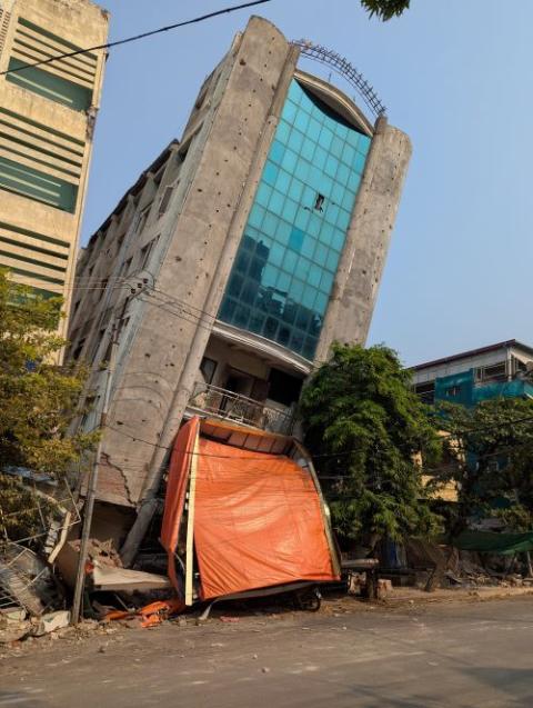 damaged building leans to one side
