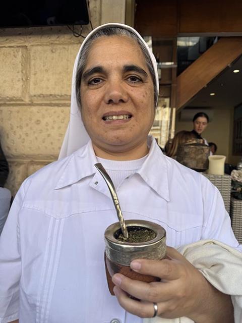 Sr. Norma Heredia holds a cup of maté, Argentina's national drink, after watching Pope Francis' coffin make its way to its final stop at Rome's Basilica of St. Mary Major April 26, 2025. Heredia, of the Sisters of Charity of Our Lady of Good and Perpetual Help, wasted no time in calling for the canonization of her fellow Argentine Pope Francis. (NCR photo/Rhina Guidos)