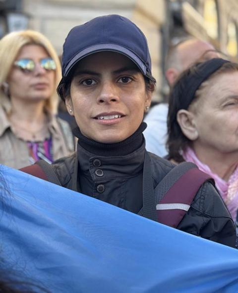 Joana Valenzuela holds the flag of Argentina outside the Basilica of St. Mary Major April 26, 2025 ahead of the pope's entombment inside. She said the pope helped young Catholics like her see the church in a more positive light and wonders what will happen now that the pope is gone. (NCR photo/Rhina Guidos)