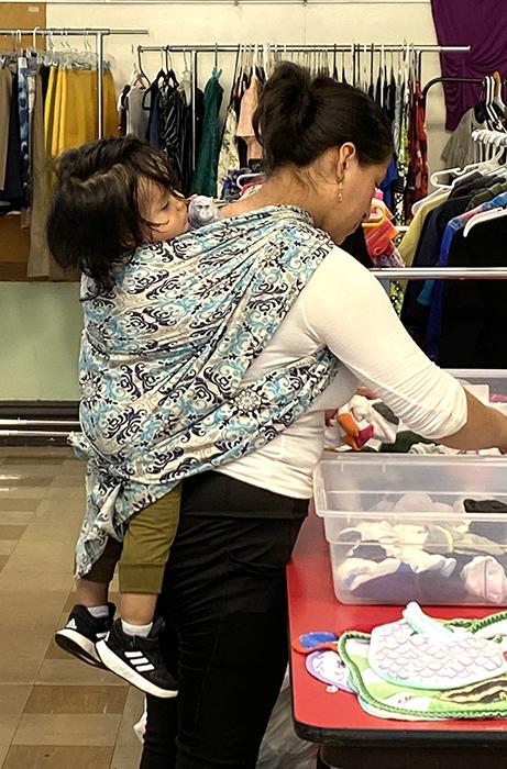 A migrant mother and her child shop for much needed clothing at a Migrant Ministry "free store." (Courtesy of Migrant Ministry)