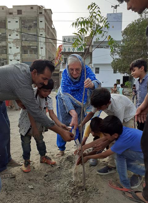 Local lawyer and social activist Soobah Bhatti joins Sr. Rebecca Conlon and children from the area in planting a tree on May 16, 2021, in Latifabad, Hyderabad. The ongoing project fosters community roots and includes dialogue with the local municipality, promoting Christian-Muslim dialogue. (Courtesy of Rebecca Conlon)