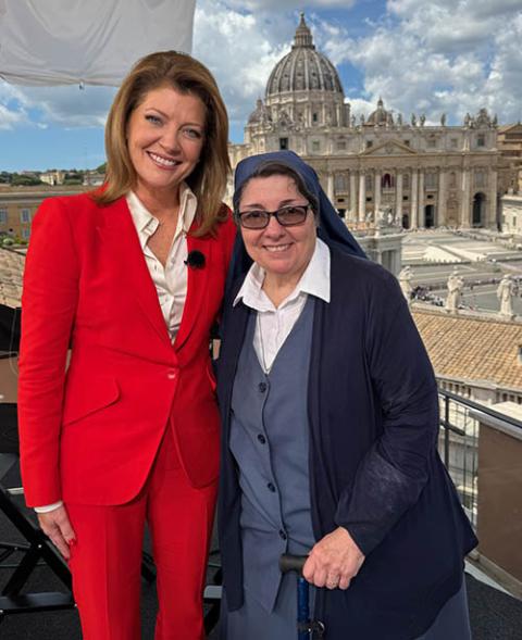 Norah O’Donnell and Daughter of St. Paul Sr. Rose Pacatte pose for a photo overlooking the Vatican during the 2025 conclave. (Courtesy of CBS News)