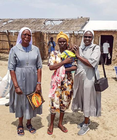 Two Catholic sisters stand with a mother and her baby at a refugee settlement in White Nile State, Sudan. (Courtesy of Sisters of the Sacred Heart of Jesus)