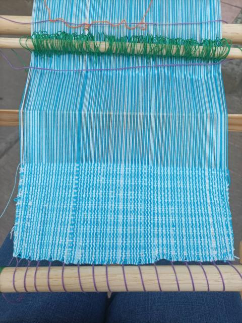 Blue threads being woven together on Munguia's loom. (Courtesy of Lourdes Munguia) Blue threads being woven together on Munguia's loom. (Courtesy of Lourdes Munguia)