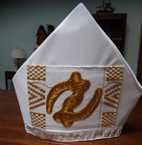 A bishop's mitre created by Sr. Jannette Pruitt. (Courtesy of Jannette Pruitt) A white bishop's mitre with gold accents.