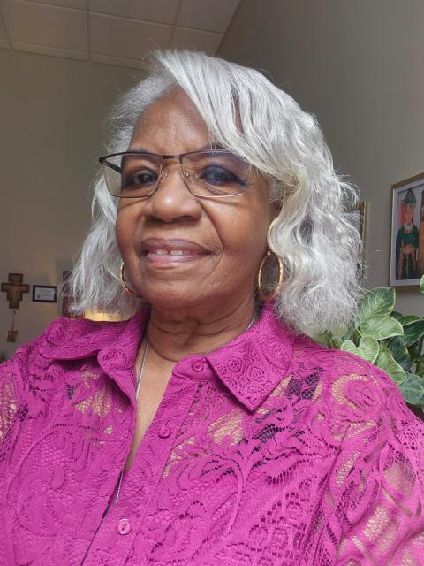 Sr. Jannette Pruitt, 76, Sisters of St. Francis, Oldenburg, Indiana. (Courtesy of Jannette Pruitt) Sr. Jannette Pruitt has light grey curly, wavy hair that reaches her neck and is wearing a magenta button-up shirt and thin-rimmed square glasses.