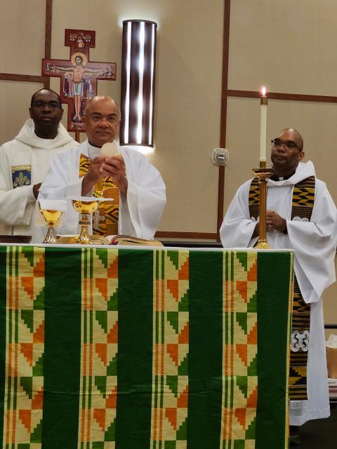 An altar cloth designed and created by Sr. Jannette Pruitt. (Courtesy of Jannette Pruitt) A dark green altar cloth with orange, yellow and lighter green stripes and geometric designs, designed and created by Sr. Jannette Pruitt, mid-Mass.