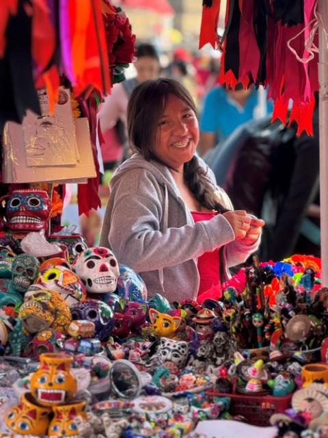 A vendor sells wares for the annual Day of the Dead "La Catrina" parade in Mexico City Oct. 26.