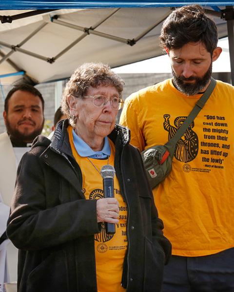 Mercy Sr. JoAnn Persch tells a crowd of worshippers at the ICE facility in Broadview, Illinois, on Nov. 1, 2025, that their request to bring Communion to the immigrants detained there was denied. (Courtesy of Chicago Catholic)