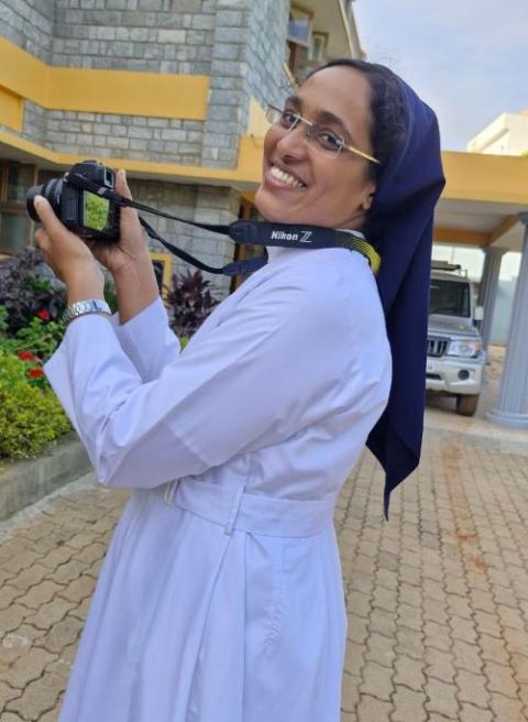 Sr. Soniya K. Chacko, a member of the Daughters of Charity of St. Vincent De Paul, poses with her camera in Vellanchira, Chalakudy, Kerala, southwestern India. (George Kommattam)