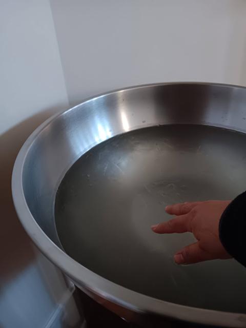 A Capuchin Poor Clare sister touches a frozen holy water font at the Veronica Giuliani Monastery in Wilmington, Delaware, Jan. 30, 2026. (Courtesy of Capuchin Poor Clare Sr. Lety Gomez)