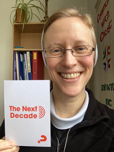 The author is pictured with "The Next Decade" postcard. (Courtesy of Kathryn Press)