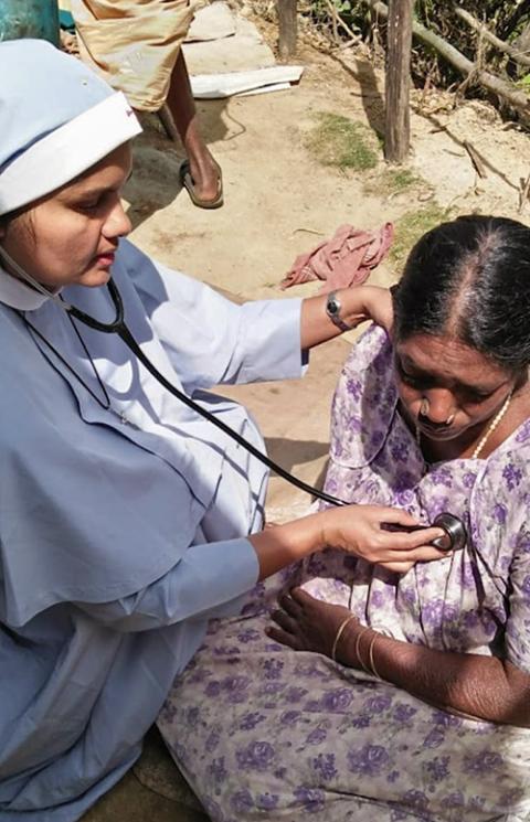 Sr. Jean Rose attends to a sick tribal woman during a community health camp in her village in the Idukki district of Kerala, India. (Courtesy of Jean Rose)