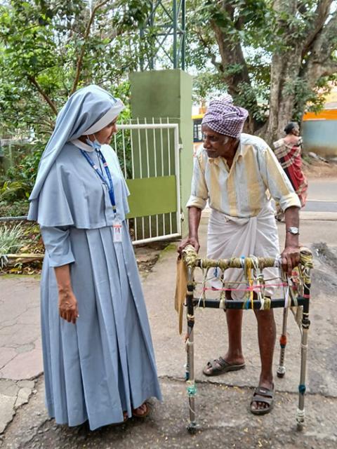 Sr. Jean Rose, a medical doctor, assists an elderly patient during a physiotherapy session at her convent premises in Marayoor village in Kerala, southwestern India. (Courtesy of Jean Rose)