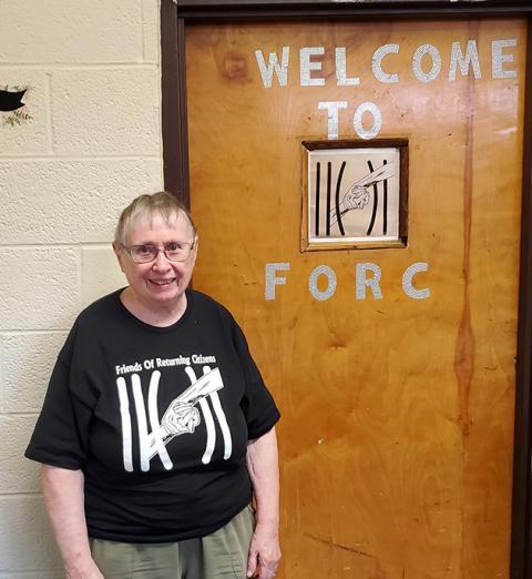 Sr. Alice Baker stands in front of the door to Friends of Returning Citizens, a nonprofit that assists formerly incarcerated people with clothing, toiletries, public transportation, housing referrals and more. (Courtesy of IHM Sisters)