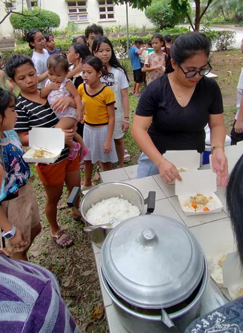 Children from the cemetery community receive a meal during a monthly gathering at the Daughters of St. Paul's central house in Pasay City. (Courtesy of Daughters of St. Paul)