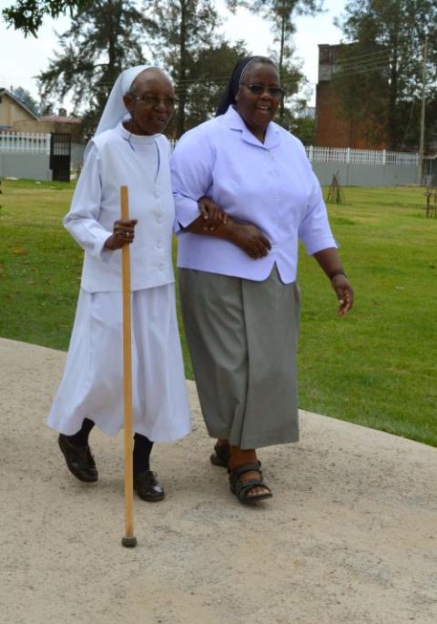Sr. Agnes Wamuyu, the executive director of the Care for Aging Sisters Association Kenya, takes a walk with Sr. Seraphine Chebet of the Sisters of Mary of Kakamega during the Conrad N. Hilton Foundation's senior staff site visit in June 2026. (Courtesy of Sr. Agnes Wamuyu)