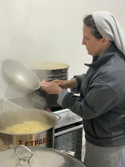 Caritas Sister Ukraine: A Caritas Sister of Jesus prepares meals for refugees from Ukraine arriving in Poland as part of the World Central Kitchen's work to feed people in crisis. (Courtesy of World Central Kitchen)
