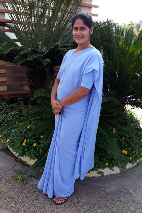 Holy Spirit Sr. Sneha Joseph, who has recovered from COVID-19, stands in front of Holy Spirit Hospital, Andheri, a suburb of Mumbai. (Provided photo)