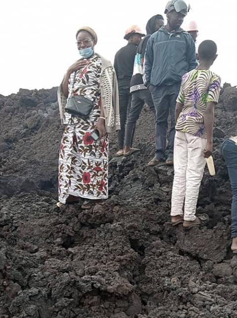 Sister Madeleine accompanies the teachers who lost their houses, which were covered by lava. She is standing on the still-hot ground. (Courtesy of Bernadette Mwavita/Ursuline Sisters of Goma)