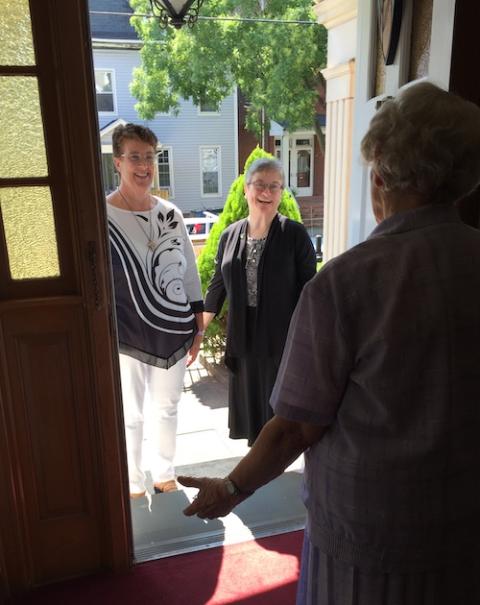 Dominican of Peace Sr. Julia Grey welcomes Cathy Buchanan, left, and Sr. June Fitzgerald, vocation director, inside on the occasion of Buchanan's acceptance into candidacy on Aug. 8 in New Haven, Connecticut. (Provided photo)