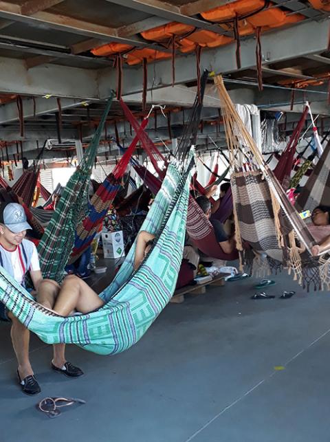 Passengers use hammocks to sleep on the dayslong trip along the Solimões River between Manaus and Tonantins in June 2020. (Courtesy of Sr. Alessandra dos Santos Santana)