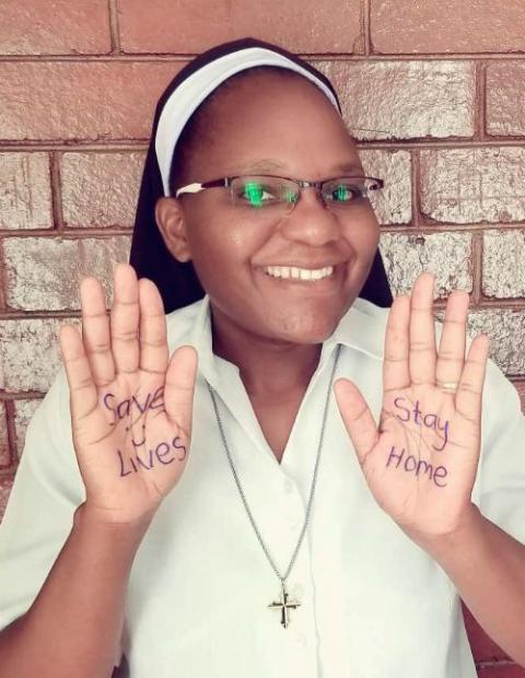 Dominican Sr. Astridah Banda displays one of the key COVID-19 messages on her hands during a campaign to encourage people to stay safe. (Provided photo)